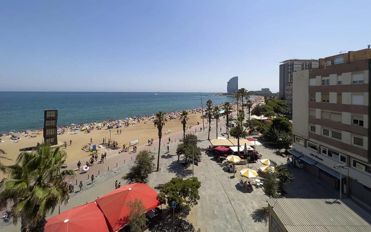 Barceloneta beach and promenade, photographed from EnjoyBCN’s Barceloneta Mar building